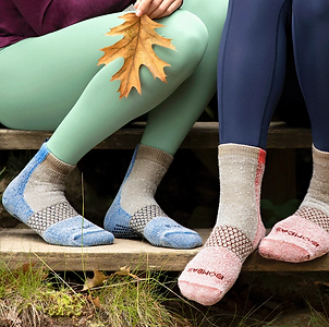 Closeup of four feet wearing Bombas socks