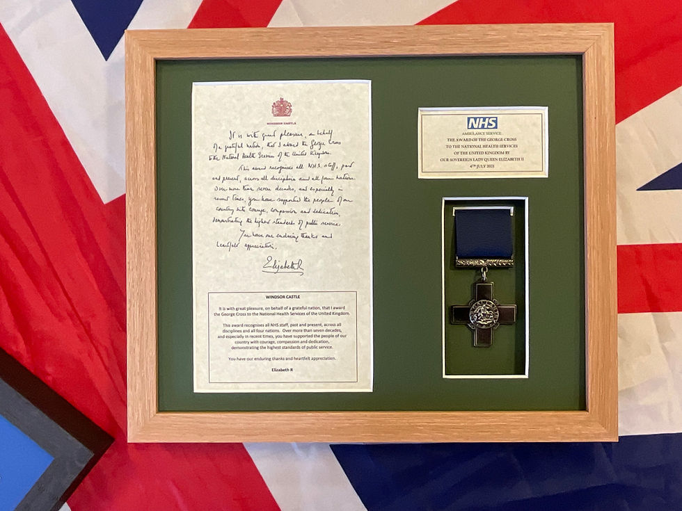 Queens George Cross award to NHS Ambulance Service with medal