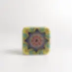 Square metal tin with a colorful mandala pattern