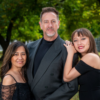 Outdoor family portrait in formal attire in Sacramento, CA in a green park