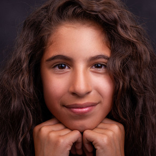 portrait of a young girl on a dark backdrop