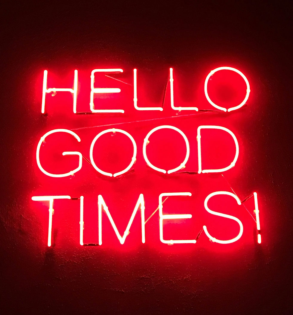 Bright red neon sign glowing with 'HELLO GOOD TIMES' in stylish lettering