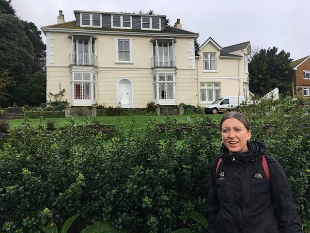 Gardener Polly Carter at Talland House by the escallonia hedge