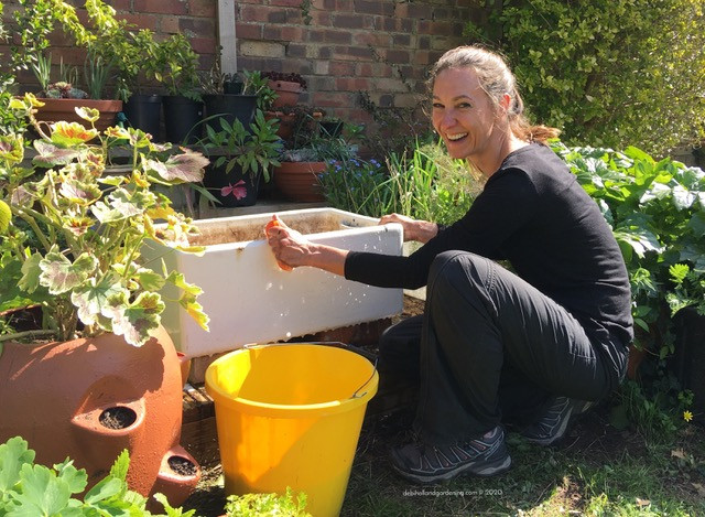 Me cleaning my Belfast sink ready for planting