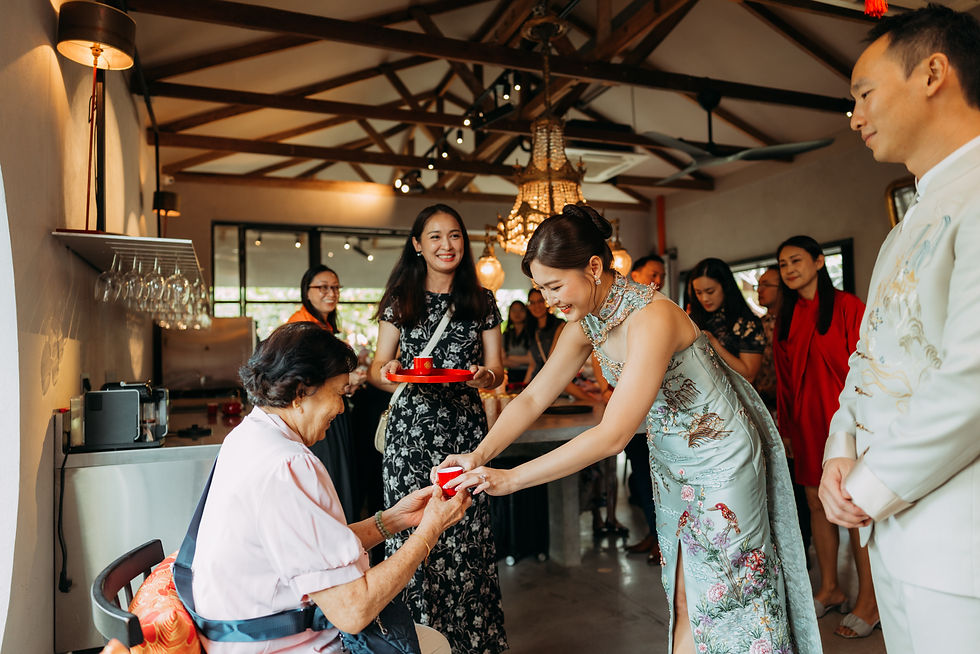 Bride serves tea to an elder during a Chinese wedding ceremony