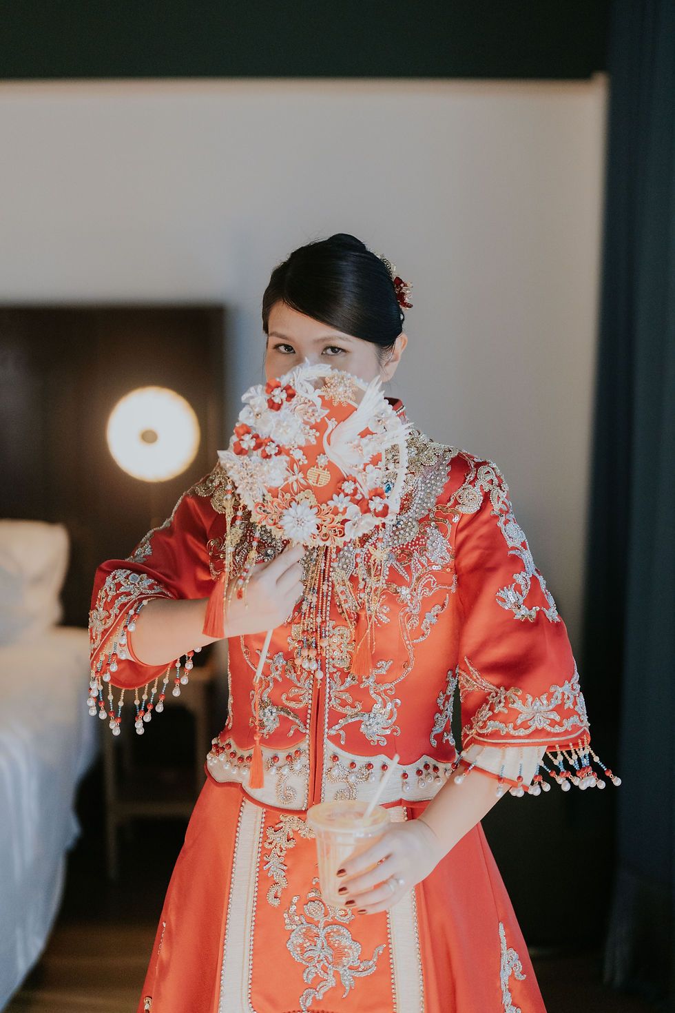 Bride wearing a traditional red Chinese wedding outfit