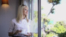 woman looking out clean windows