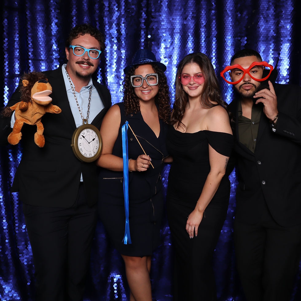 Wedding guests posing in the photo booth at a September wedding in Utah