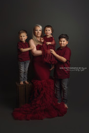 Mother holding newborn wrapped in soft blanket during studio session