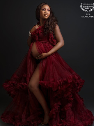 Expecting mother photographed in a couture maternity dress during a Wolverhampton studio session.
