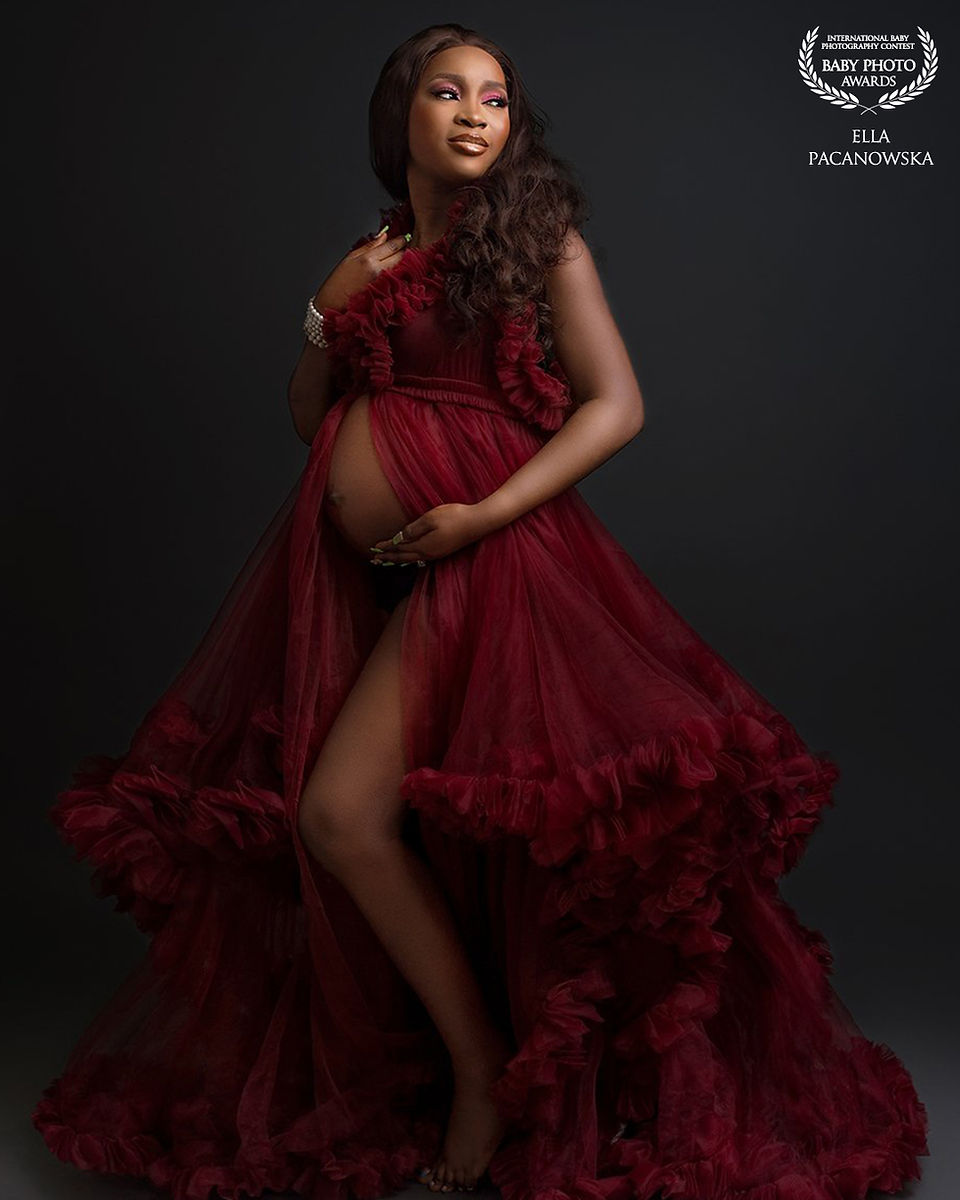 Expecting mother photographed in a couture maternity dress during a Wolverhampton studio session.