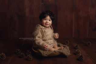 Baby sitting confidently in a luxury photography studio in Wolverhampton.