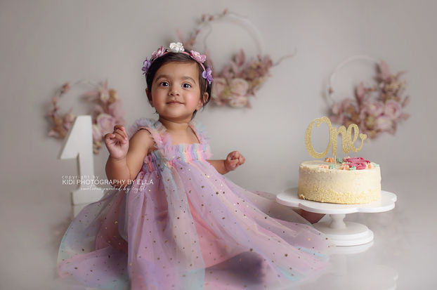 First birthday cake smash session with soft neutral colours and timeless styling.