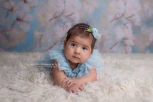 Studio sitter photoshoot with soft textures, neutral tones, and delicate light.