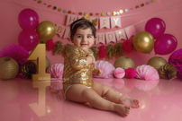 Natural first birthday photography with cake smash and splash experience.
