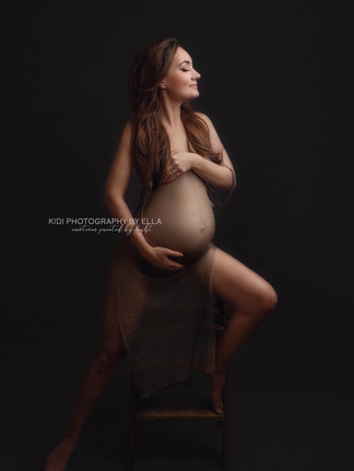 Luxury maternity photography with soft textures and romantic atmosphere