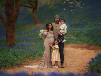 Family spring mini session in a woodland filled with bluebells