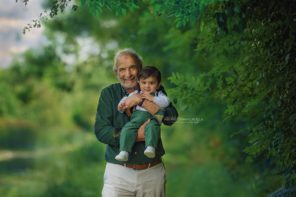 Parents cuddling toddler in meadow – family photographer West Midlands