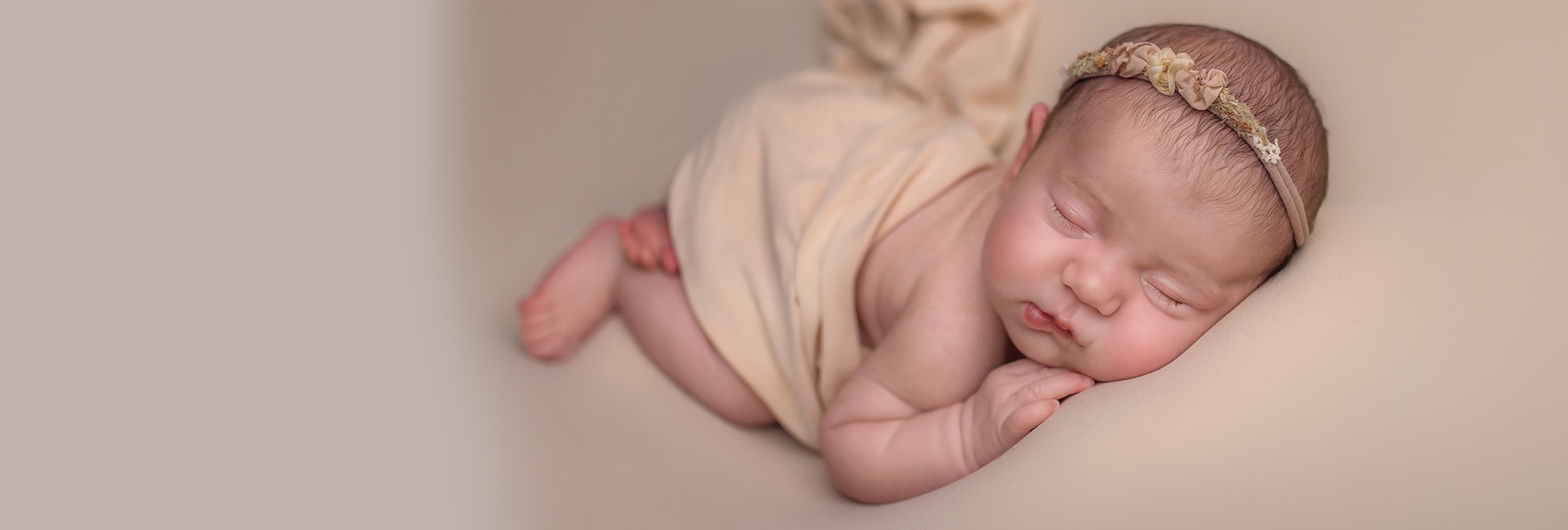 Sleeping newborn baby wrapped in cream blanket – newborn photographer Wolverhampton