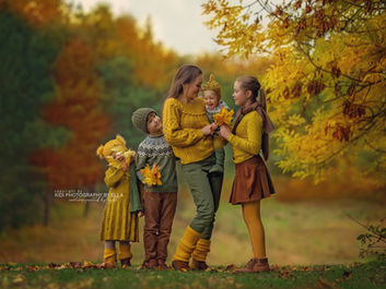 Family playing hand in hand during outdoor photoshoot