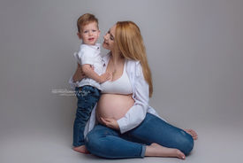Expectant mother smiling in white gown – maternity photography Wolverhampton