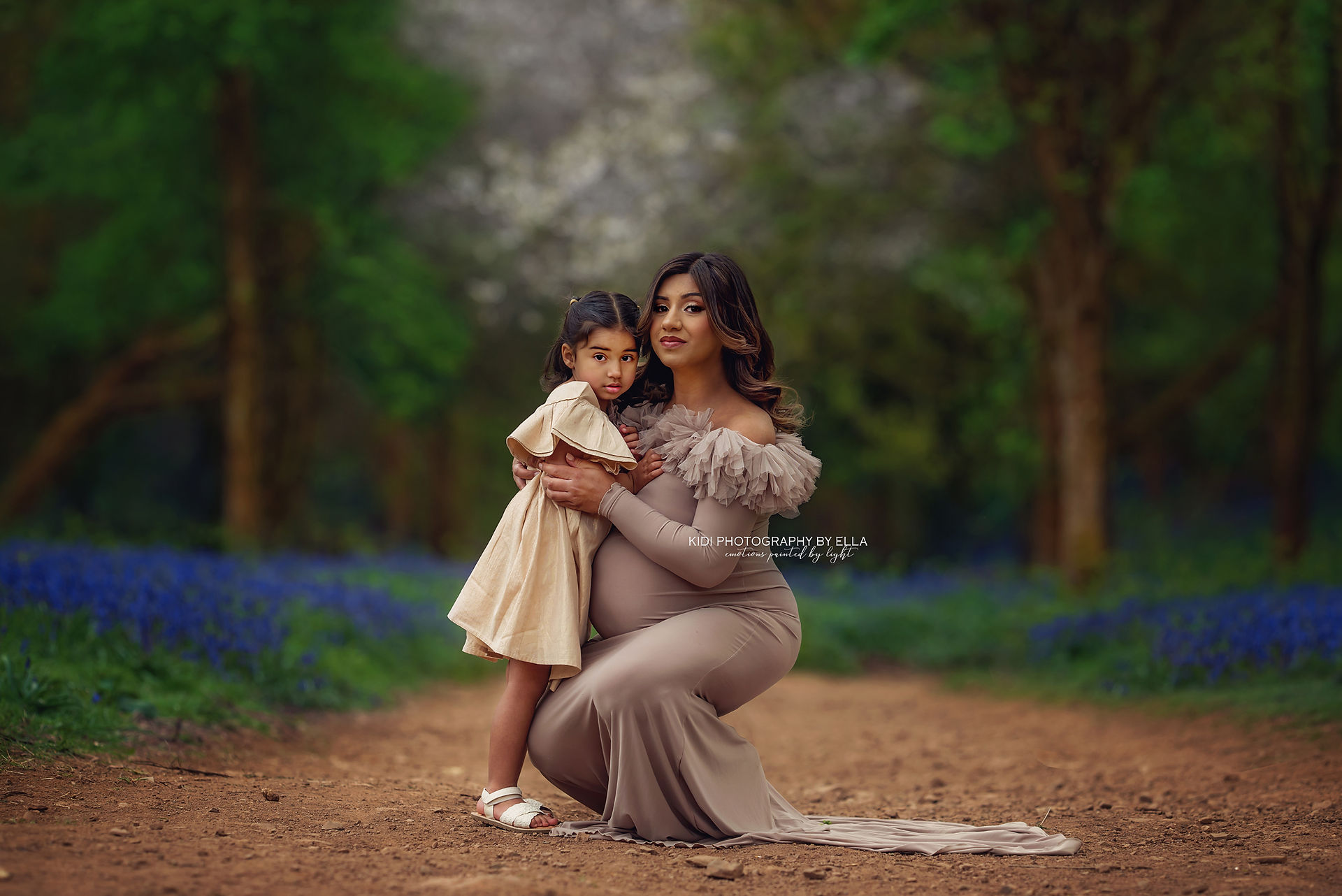 Mother cuddling her child in a dreamy bluebell forest mini session