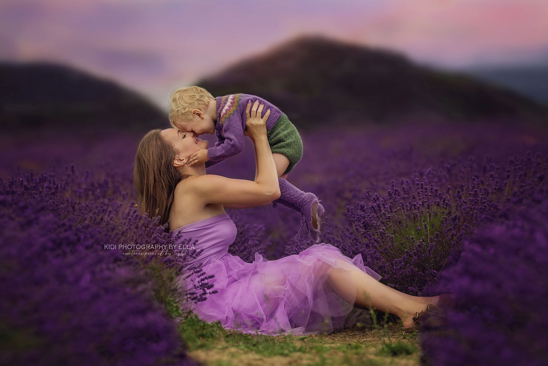Child running freely among lavender rows during a summer photoshoot.