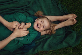 Happy baby girl smilling during outdoor session in Birmingham.