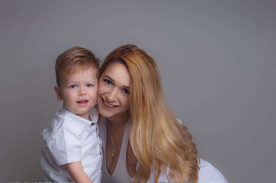 Soft and timeless studio portrait of a mum holding her newborn during a professional Mum and Me photoshoot.
