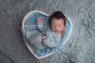 Luxury newborn photography session with a sleeping baby in a neutral colour palette