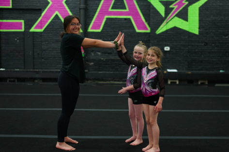 Coach giving athletes high fives.