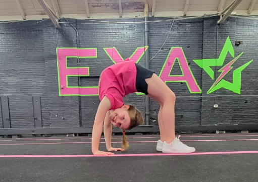 Tumbling athlete performing a bridge. 