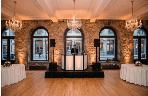 Luxury wedding DJ in Montreal mixing at Old Montreal venue