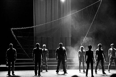 Ensemble of performers training synchronization, rhythm, and group coordination on stage