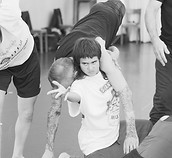 Participants practicing close partner interaction and physical connection during a movement training session at NIPAI in Berlin.