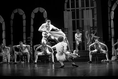 Performers executing dynamic lifts and physical composition in movement directing rehearsal
