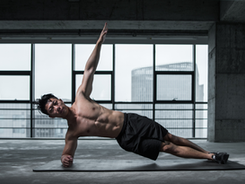 A muscular man in a side plank