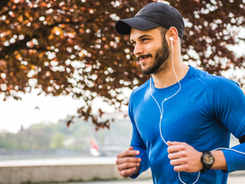 A healthy man jogging with earphones