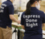 Express Done Right workers in warehouse, wearing masks, packing boxes.