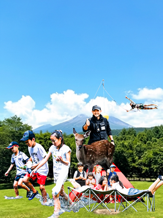 青空の下、芝生の上で遊ぶ子供たちと、背景にそびえる山々