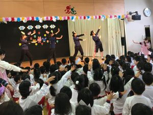 ステージで踊る子供たち。観客席の子供たちも一緒にダンスを楽しんでいます。