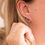 Thumbnail: woman wearing circle stud earrings
