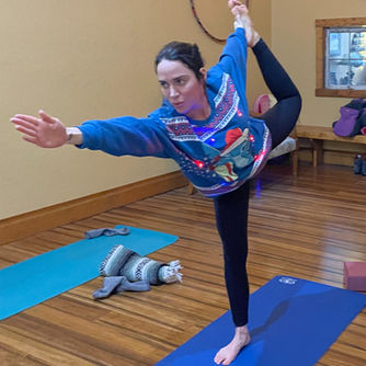 Yoga student on a yoga mat doing a yoga pose.