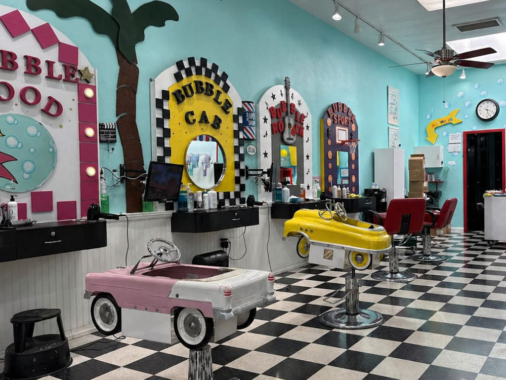 Inside the Bubble Cuts hair salon in Studio City with themed car chairs