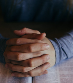 man holding his hands on open book_edite