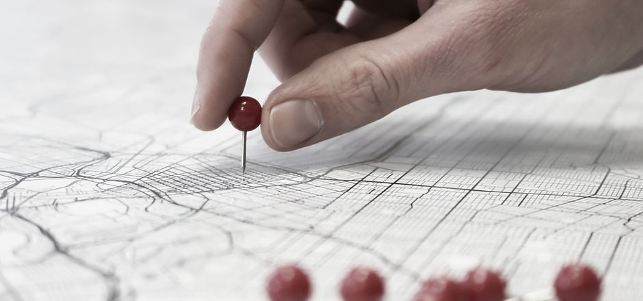 Placing red push pins into city street m