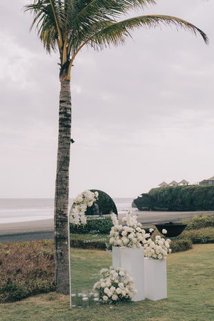 Luxury wedding ceremony setup on the beachfront lawn at Soori Bali with ocean views by The Vilia