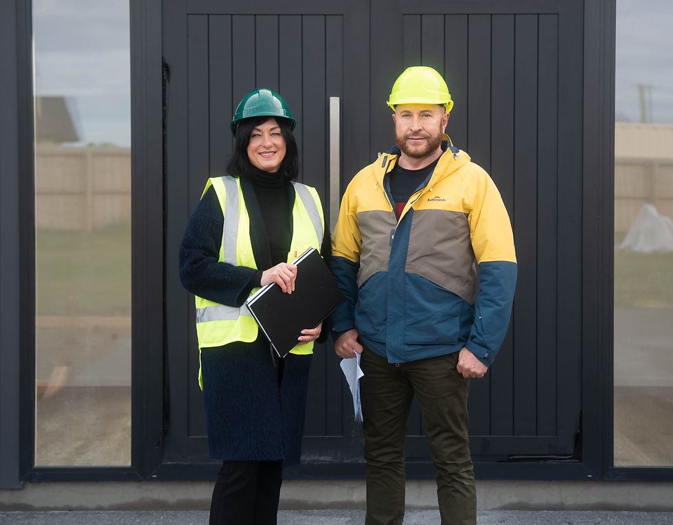 Kian Clements-Ormond and team member in hard hats and safety vests at a construction site