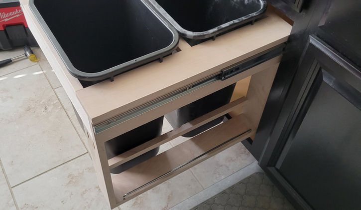 This custom-built unit features hidden garbage and recycling bins with convenient side storage, combining practicality and style. Perfect for keeping your space organized and clutter-free, it’s a seamless addition to any kitchen or utility area.