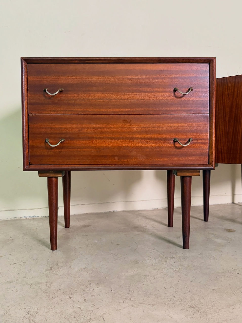 Thumbnail: Mid-century bedside tables with two drawers each, resting on tapered legs